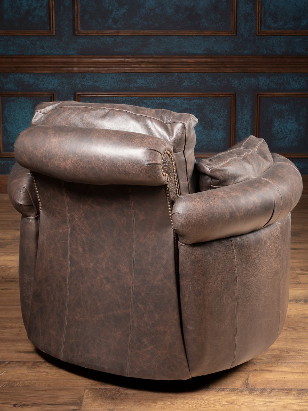 Dusk Leather Snug Swivel Recliner in a Full-Grain leather with a crackle finish in a rustic living room.