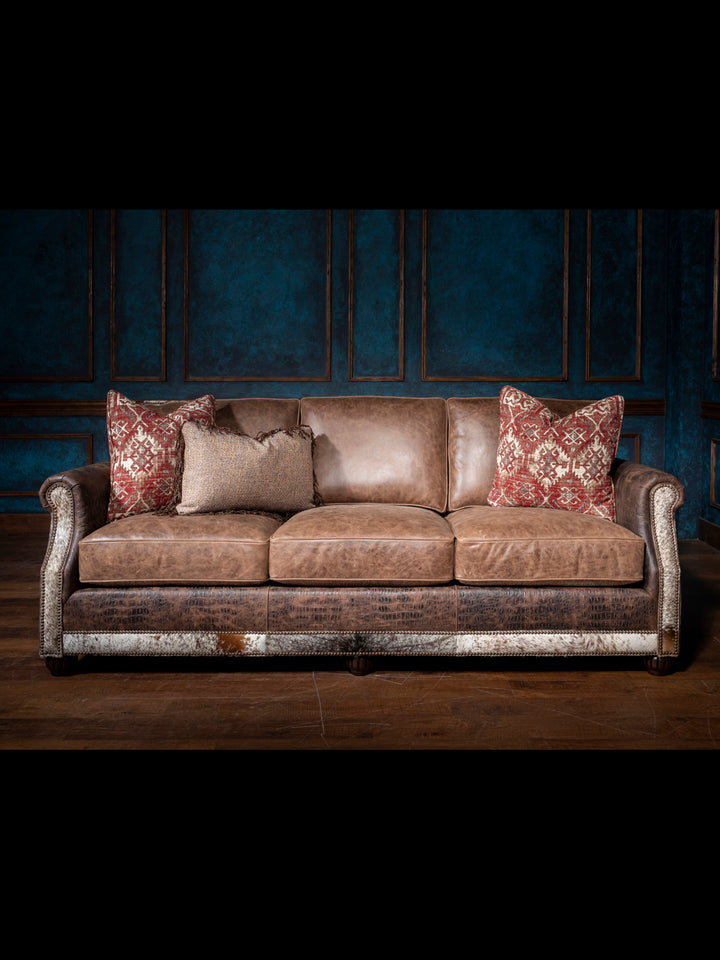 Luxurious Leather and Fabric Sofa with full grain brown leather seats and cowhide accents in a western living room.