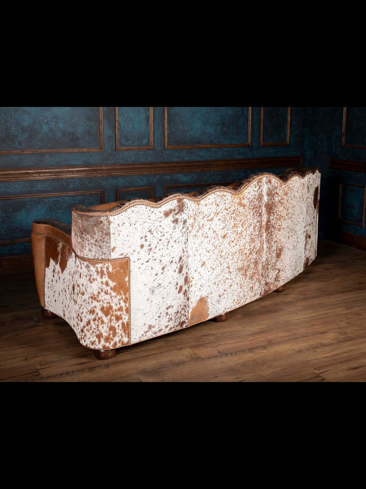 Golden Range Leather Sofa with cowhide accent paneling on the outside back in a living room space.