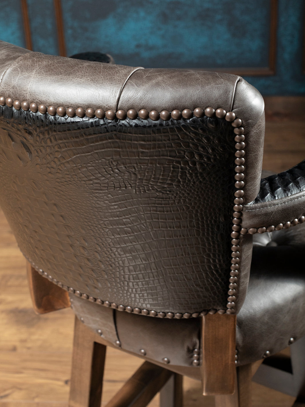 Tufted Greystone Leather Bar Stool with black crocodile accents in a close up view.
