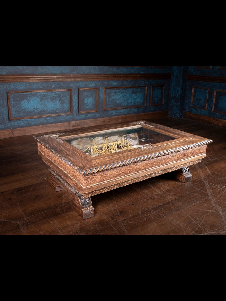 Saddle Ridge Shadow Box Coffee Table with hand carved western designs and floral embossed leather inlays in a rustic room.