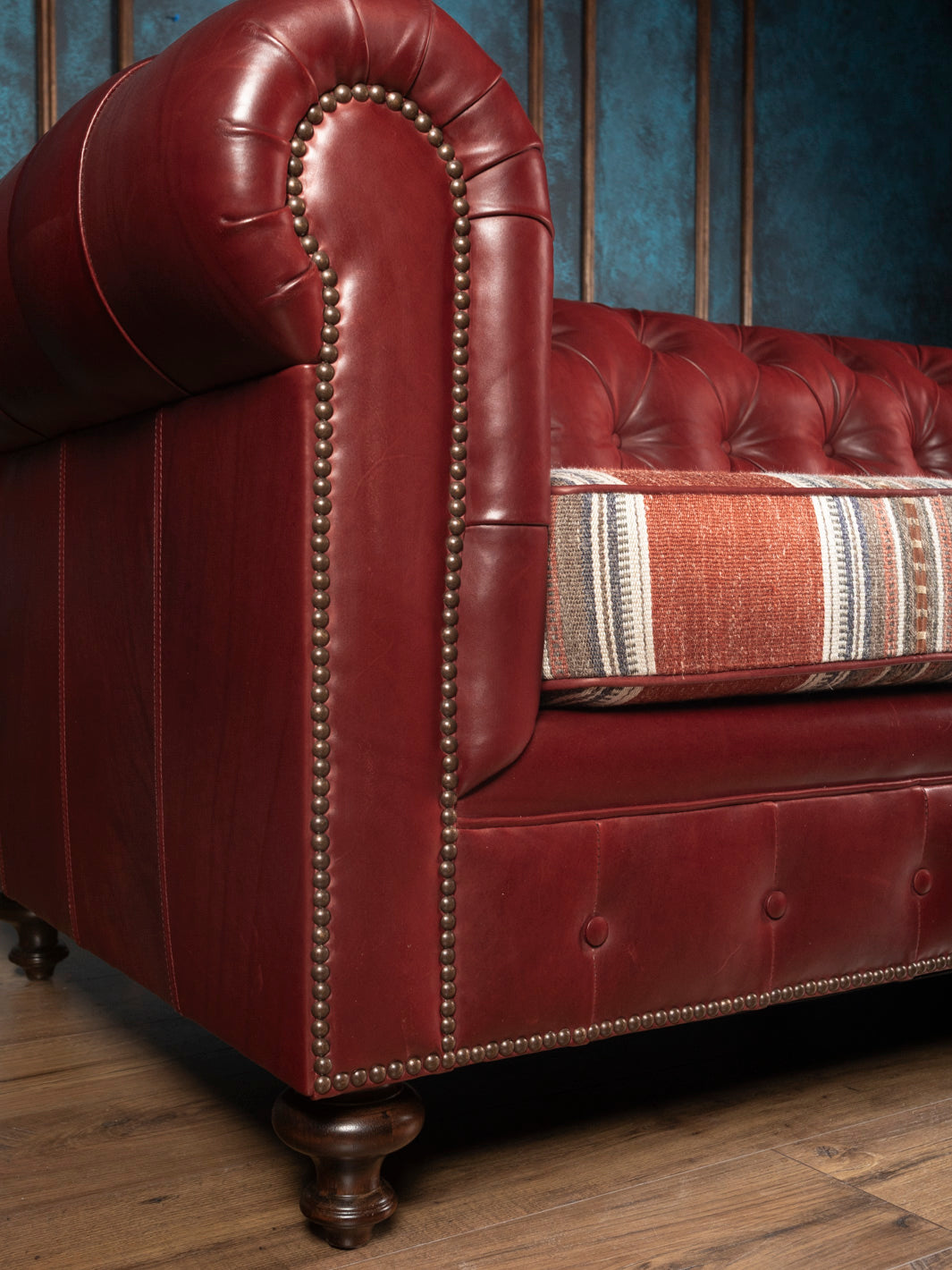 Side angle view of the West Texas Estate Western leather sofa emphasizing deep button tufting and detailed antique nailhead trim work.