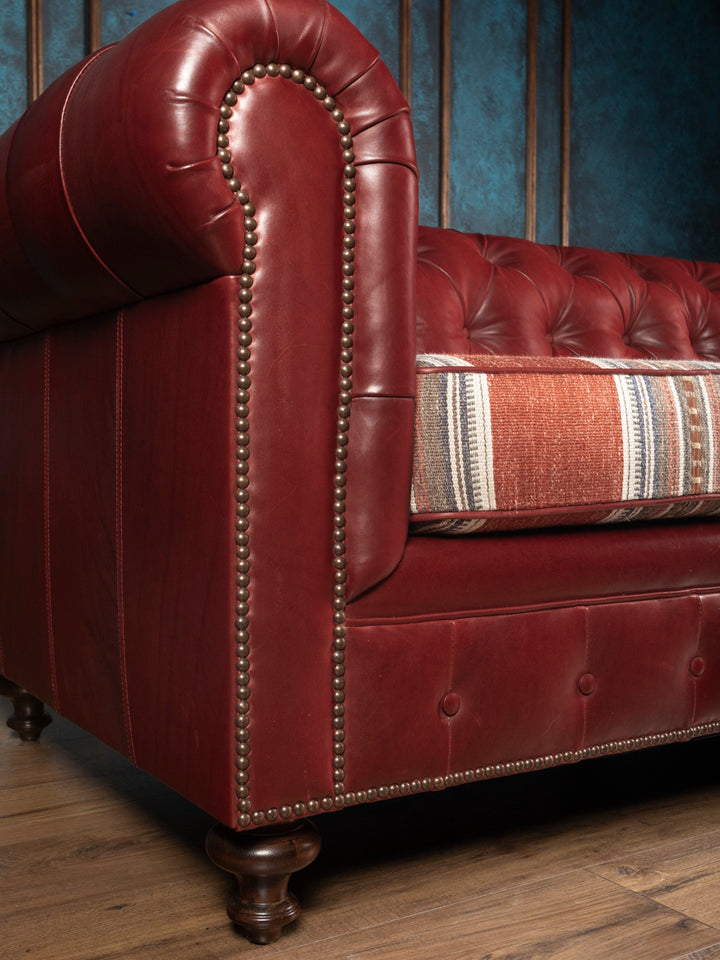 Side angle view of the West Texas Estate Western leather sofa emphasizing deep button tufting and detailed antique nailhead trim work.
