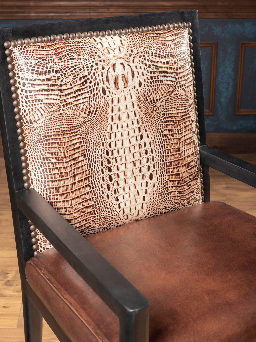 Ivory Crocodile Leather Dining Arm Chair with a burnished brown leather seat and crocodile accents in a close-up view.