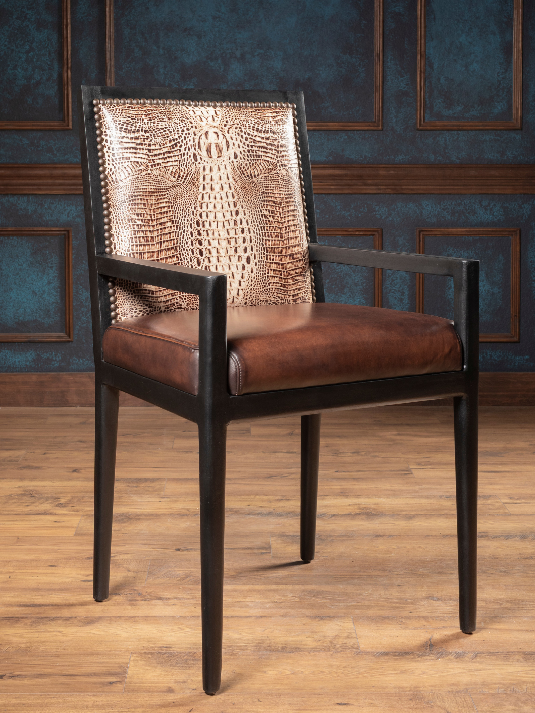 Ivory Crocodile Leather Arm Dining Chair shown with antique black solid wood arms in a western dining space.