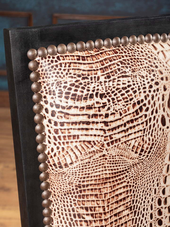 Ivory Crocodile Leather Dining Chair with croc embossed detailing and exposed wood frame in a close up view.