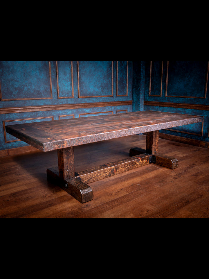 Knotty Alder Rustic Dining Table in solid knotty alder wood with hand-hewn edge and trestle base in lodge dining room.