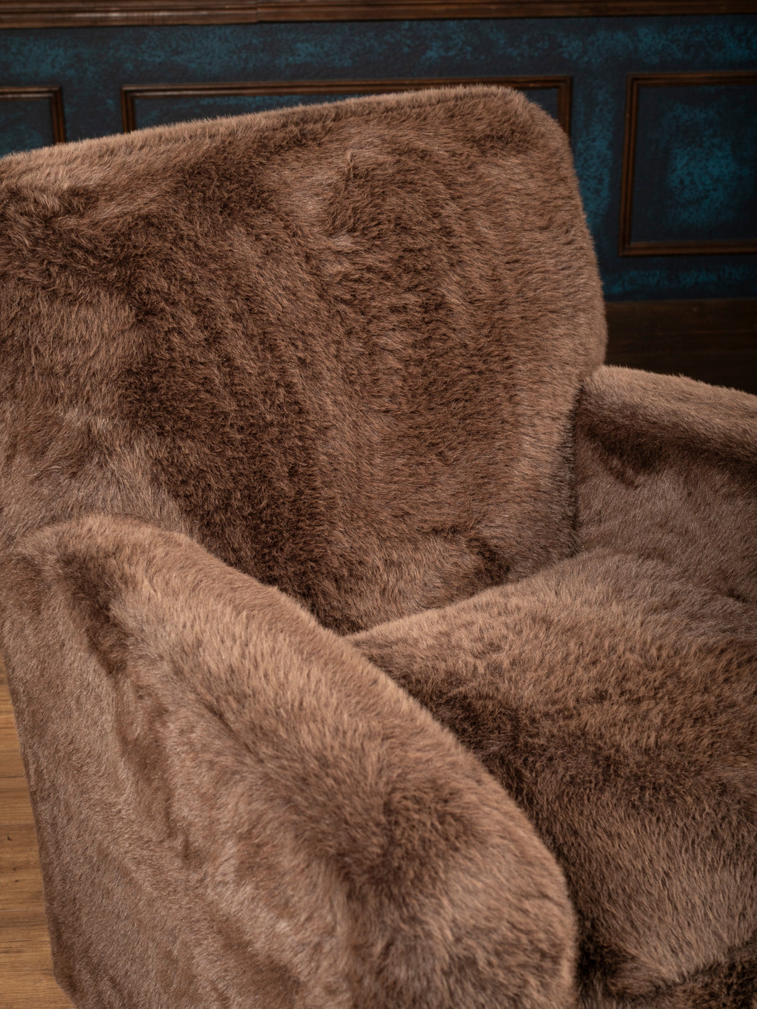 Close-up of the Kodiak Grizzly-Brown Swivel Chair showing brown faux fur on the backrest, arm, and seat cushion.