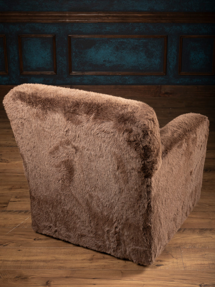 Rear angled view of the Kodiak Grizzly-Brown Swivel Chair showing its fully upholstered brown faux fur back and side.