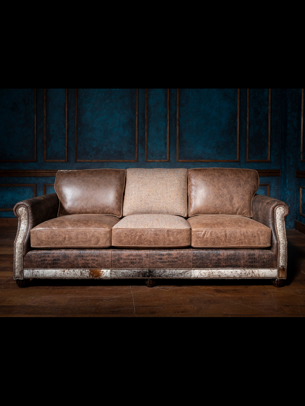 Luxurious Leather and Fabric Sofa with full grain leather upholstery seats and crocodile trim accents in living space.  