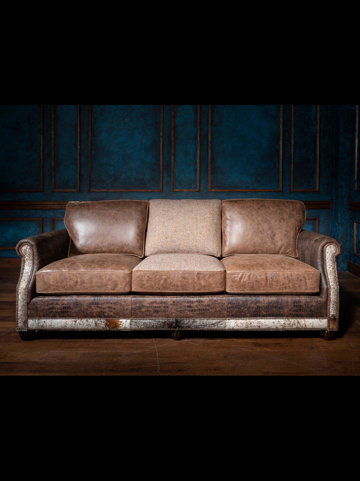 Luxurious Leather and Fabric Sofa with full grain leather upholstery seats and crocodile trim accents in living space.  