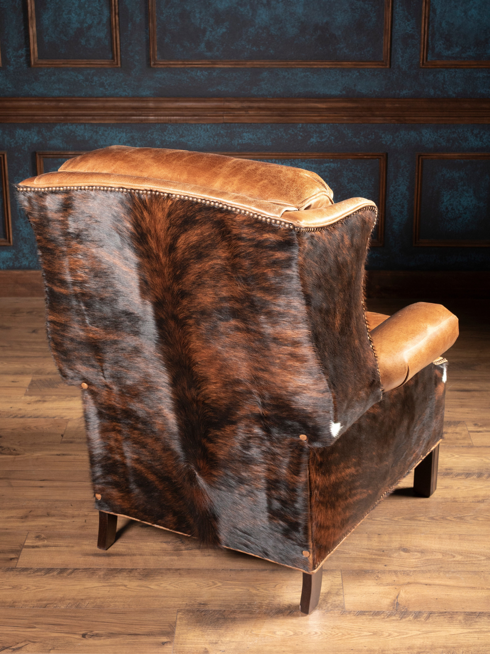 Brindle Ridge Leather Recliner with tan leather and hair-on-hide accents on the outside back in a Western living space.