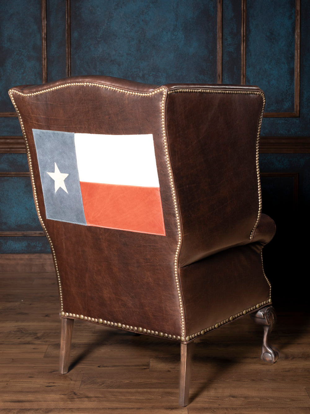 Texas Legacy Leather Wingback Chair with brown full-grain leather and Texas flag panel on the back in a western space.