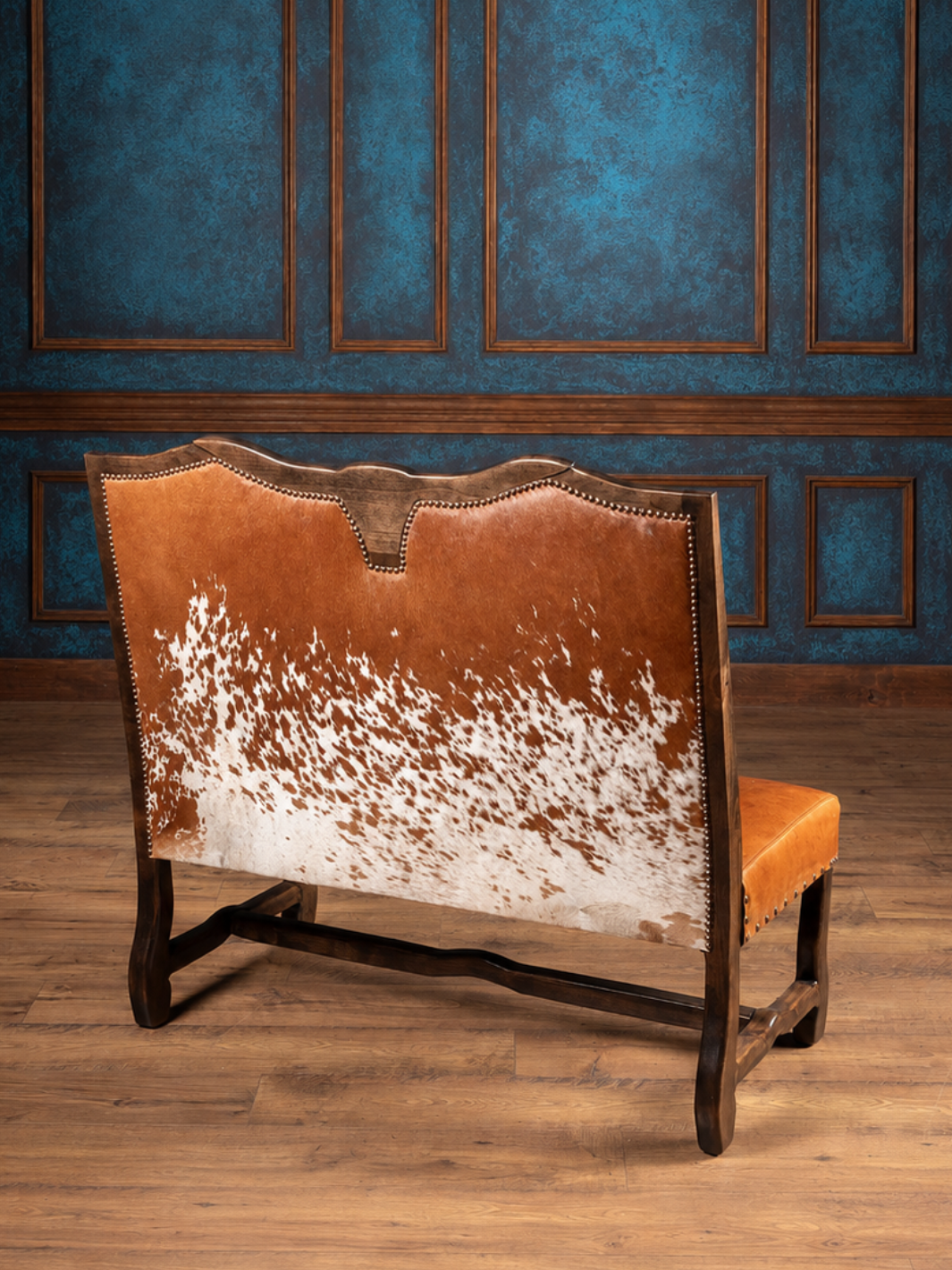 Rear view of the Longhorn Leather Bench showcasing genuine speckled red hair-on-hide detailing in a western entryway.
