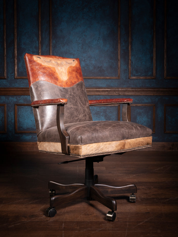 Front view of the longhorn leather desk chair highlighting the hand-tooled longhorn design, dual-tone leather upholstery, and nailhead accents, perfect for a rustic or western-themed office.