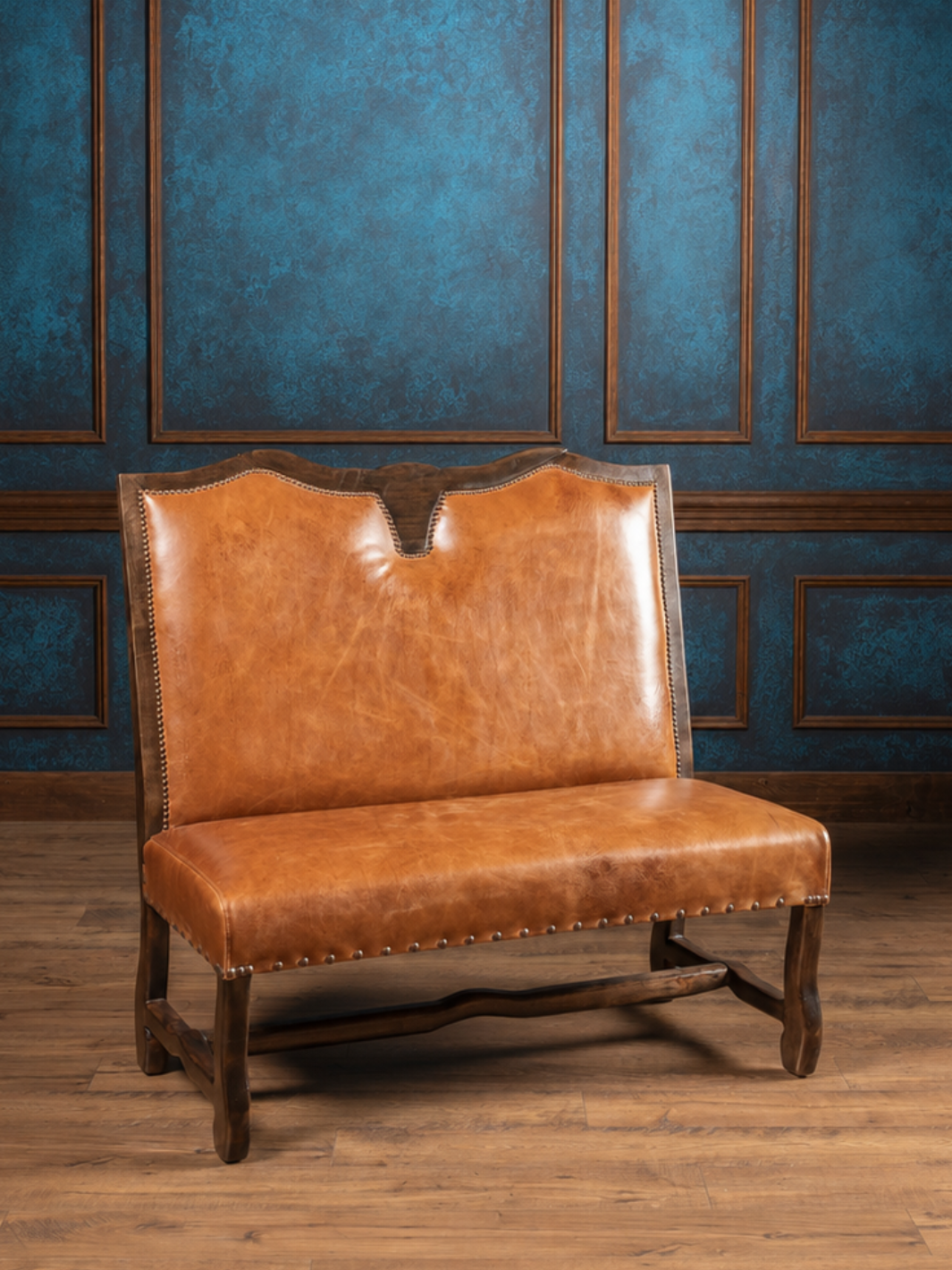 Front view of the handcrafted Longhorn Leather Bench upholstered in full-grain buffalo leather with a hand-carved longhorn crest and solid hardwood frame.