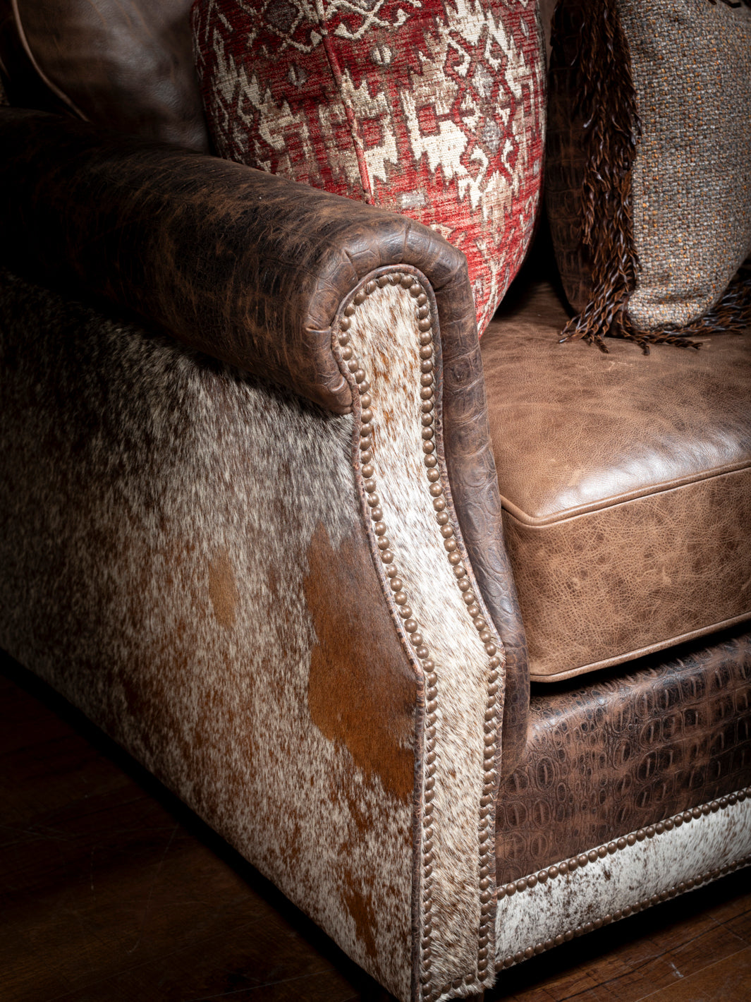 Luxurious Leather and Fabric Sofa with hair-on-hide accents and crocodile trim shown in a close-up view.