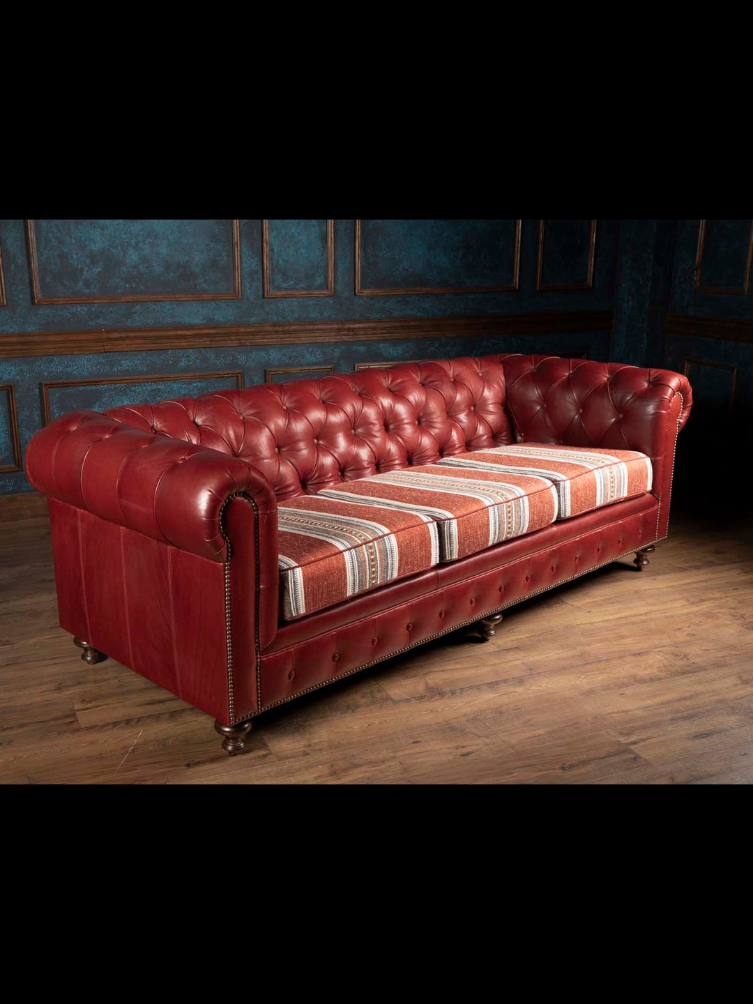 Three quarter perspective view of the West Texas Estate Chesterfield leather couch displaying full length scale and deep button tufted backrest.