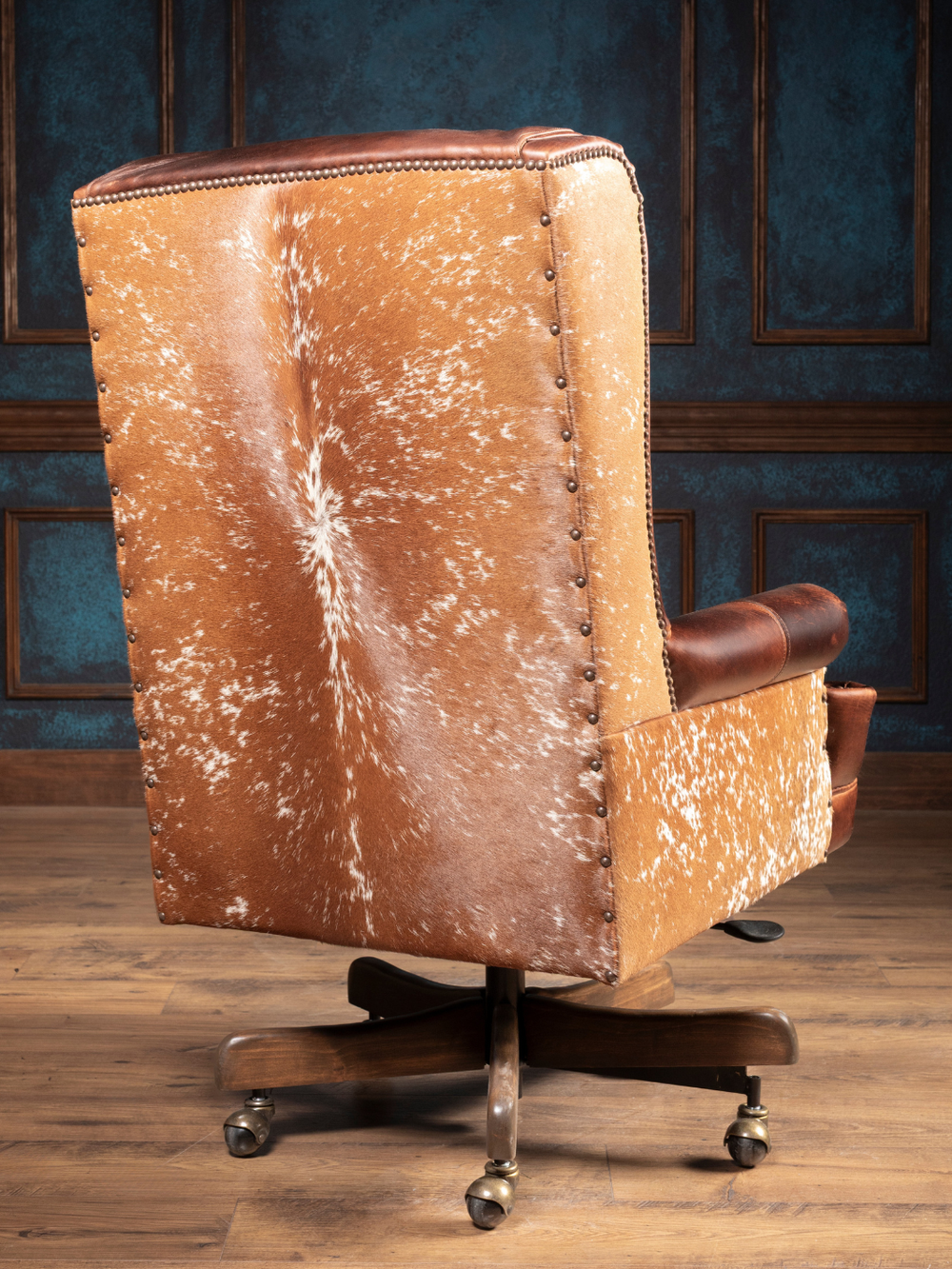 Midland Executive Leather Desk Chair with a speckled cowhide back and nailhead trim, styled in a Western office.