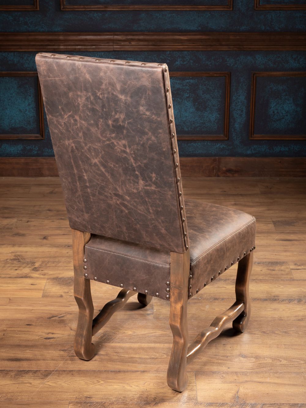 Mustang Leather Dining Chair in distressed brown leather with a solid hardwood frame, in a western dining space.