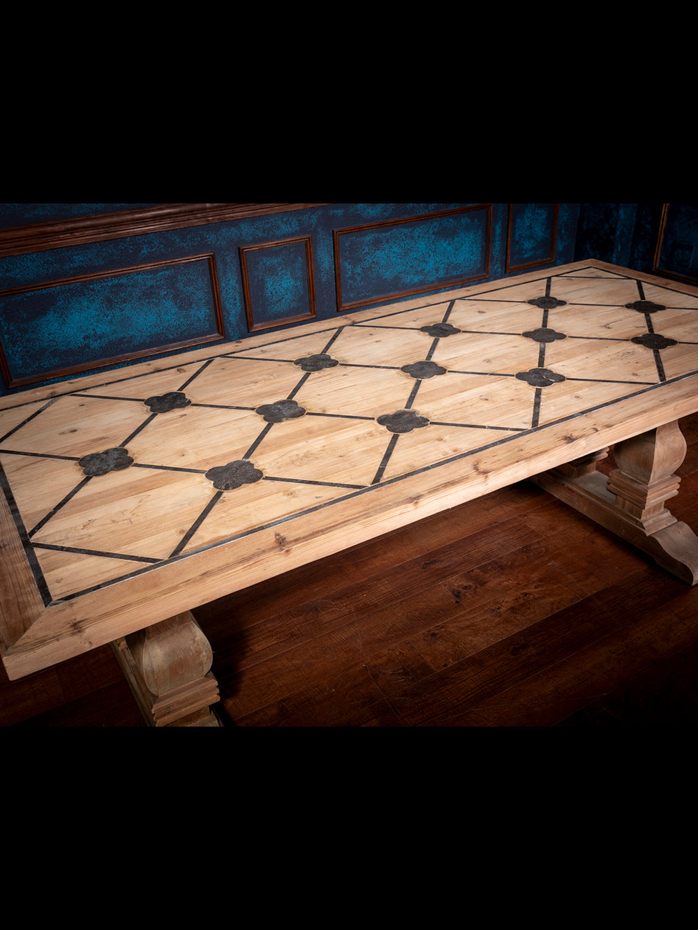Close-up of tabletop highlighting blue inlay detail and natural pine wood grain