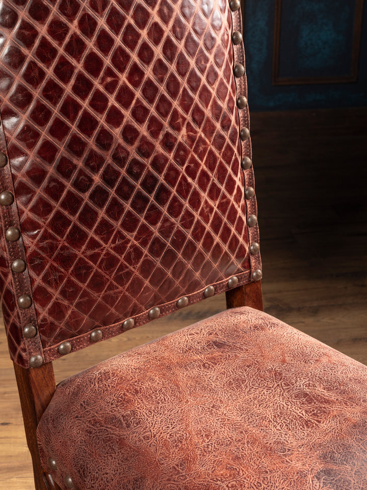 Close-up of burgundy-brown full-grain leather with diamond stitching on the Prescott dining chair