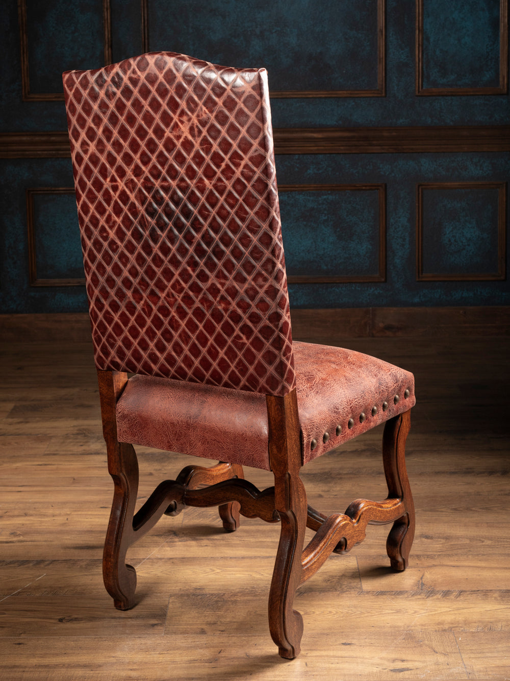 Back view of the Prescott leather dining chair with diamond-pattern full-grain leather and carved hardwood frame