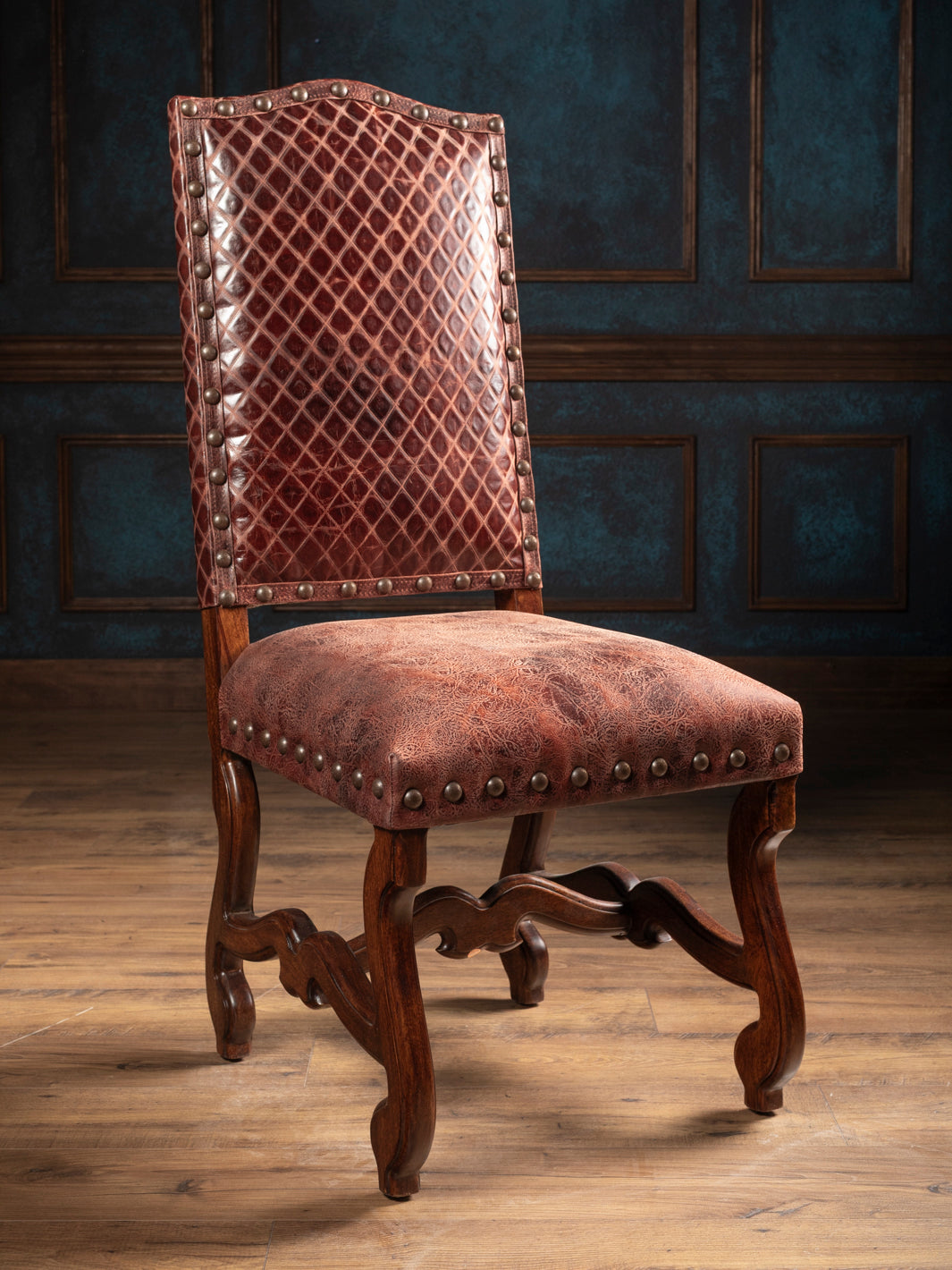 Prescott Western leather dining chair with distressed full-grain leather, diamond-stitched back, nailhead trim, and carved hardwood frame.