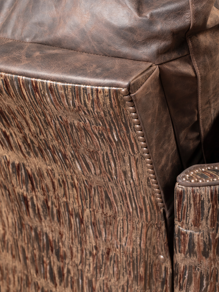 Rimrock Leather Snug Swivel Recliner with embossed leather side panel and nailhead trim, shown in a close-up view.