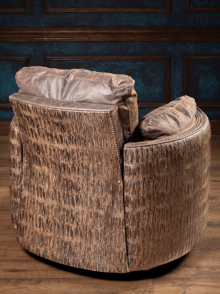 Rimrock Leather Snug Swivel Recliner with embossed leather accents on the outside back, styled in a rustic living space.