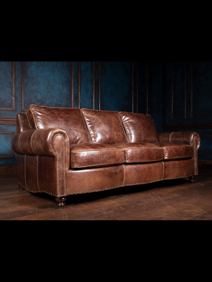 Rolled Arm Leather Sofa in Dark Rum leather with warm brown undertones in a moody western living room.