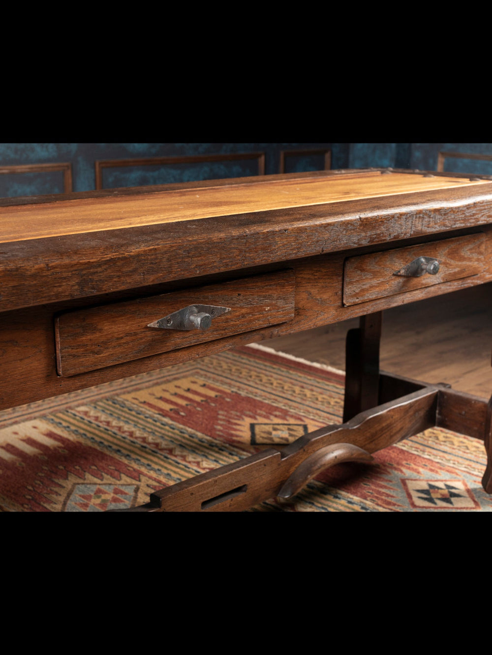 Vintage wooden desk with drawers on a patterned rug