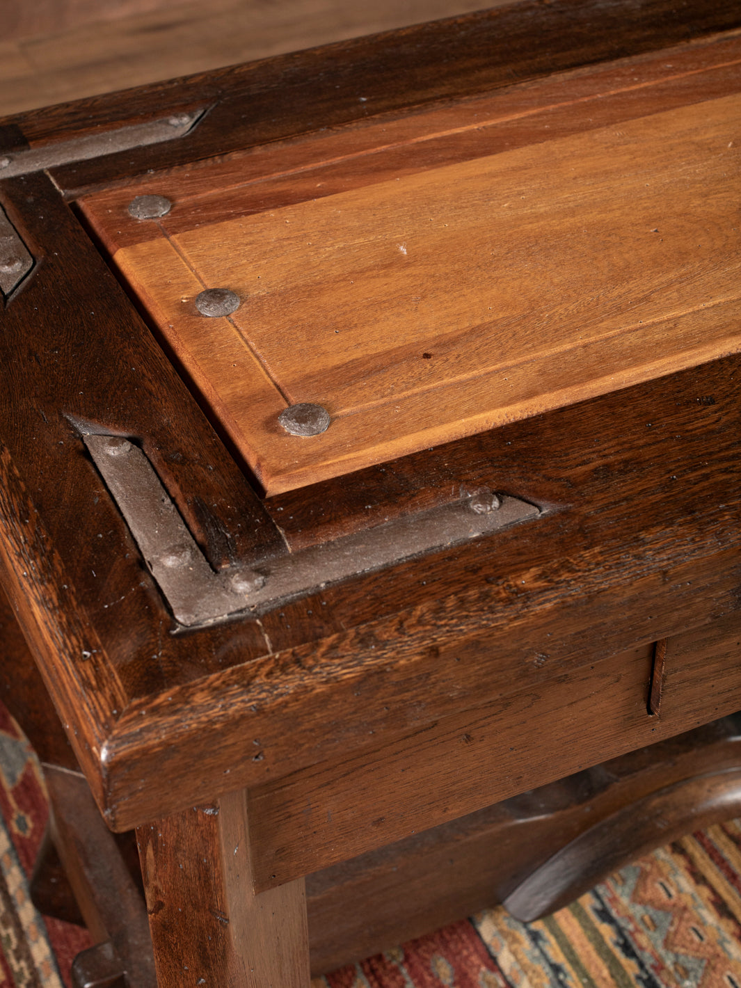 Close-up of a wooden console with metal corner brackets
