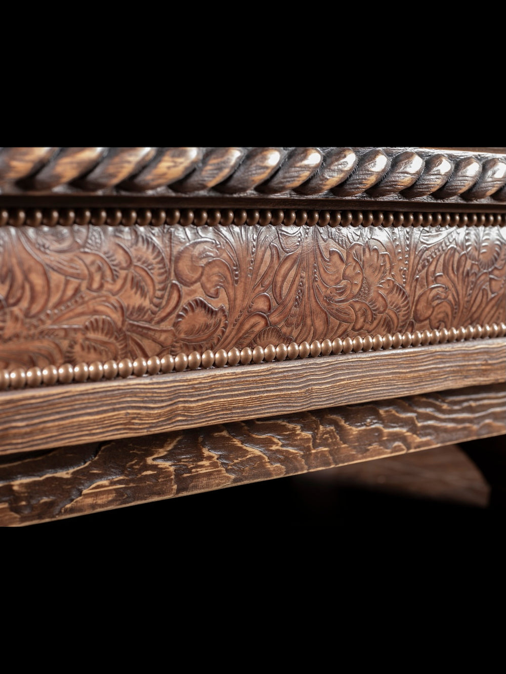 Saddle Ridge Shadow Box Coffee Table in solid wood with embossed brown floral leather and brass nailheads in a close-up view.