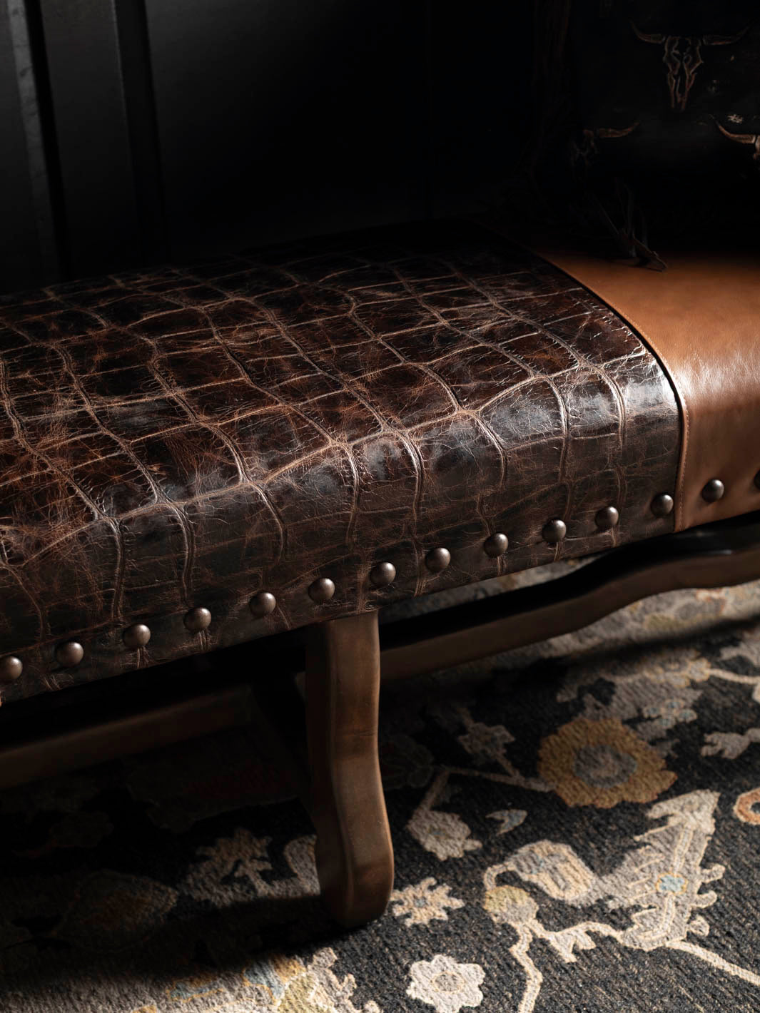 Close-up of the Santa Fe leather bench featuring jumbo crocodile-embossed leather, decorative brass nailhead trim, and handcrafted hardwood construction.