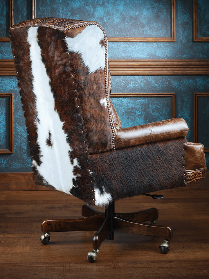 Santa Fe Western Desk Chair with brindle cowhide accent on outside arms and back in a western office space. 