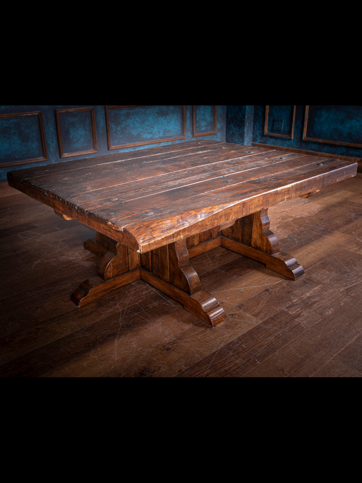 Large wooden table with a dark finish in a dimly lit room.