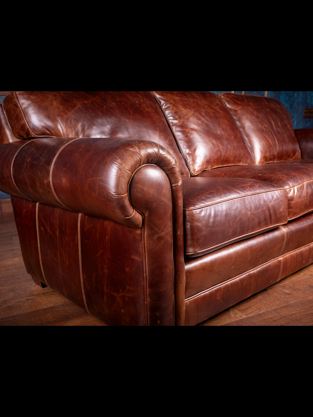 Sierra Leather Sofa in brown Chestnut full grain leather showing natural hide grain in a studio setting.