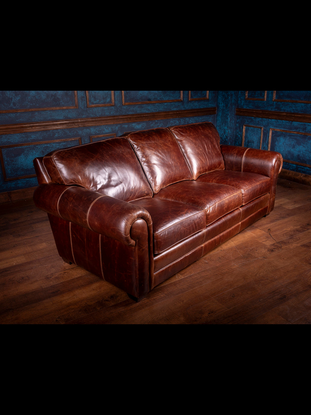 Sierra Leather Sofa in brown Chestnut leather with 3 plush cushions and straight back frame design in spacious rustic room. 