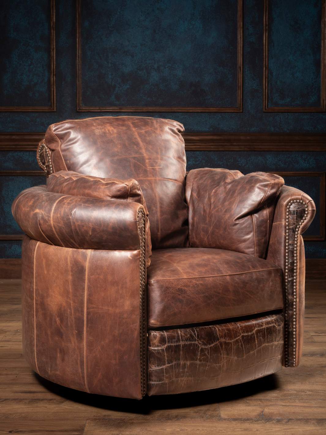 Chocolate Leather Snug Swivel Recliner in Hollis chocolate leather with embossed gator accents, styled in a western space.
