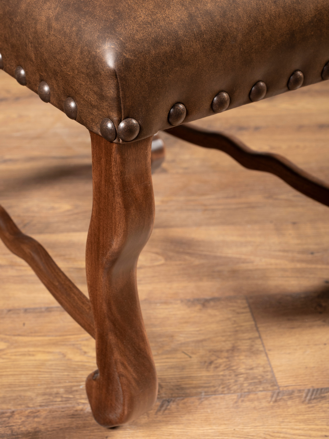 Southwestern Stripe Leather Dining Chair with brown carved legs crafted from kiln-dried wood in a close up view.