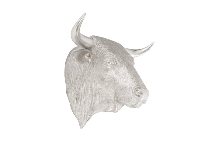Silver bull head sculpture on a white background