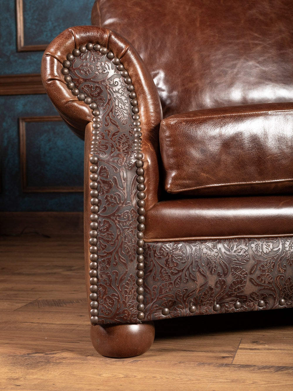 Texas Luxe Leather Curved Sofa with a rolled arm design in with embossed leather accents in a close up view.