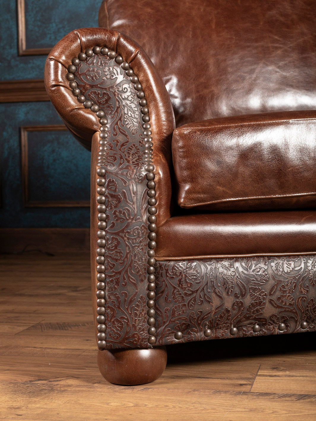 Texas Luxe Leather Curved Sofa with a rolled arm design in with embossed leather accents in a close up view.
