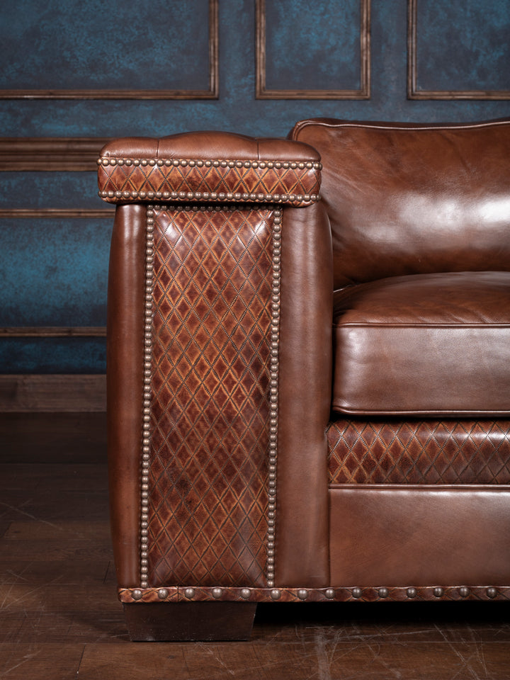 Tufted Cigar Lounge Leather Sofa in brown leather with diamond stitch leather trim in a rustic living room space.