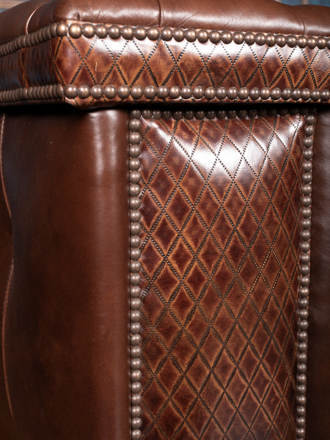 Tufted Cigar Lounge Leather Sofa in brown full grain leather and diamond stitch trim in a close-up view. 