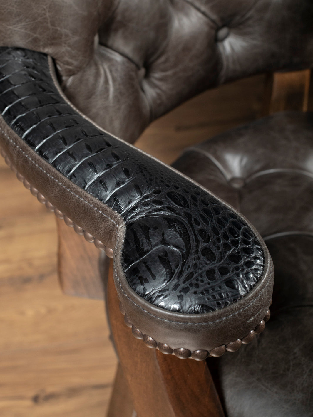 Tufted Greystone Bar Stool with embossed crocodile accents and grey leather in a close-up view. 
