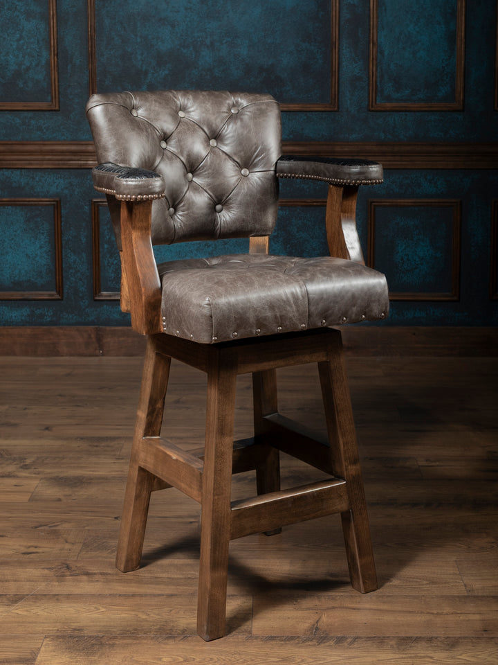 Tufted Greystone Leather Bar Stool in grey leather with tufted back and seat in a rustic bar space.