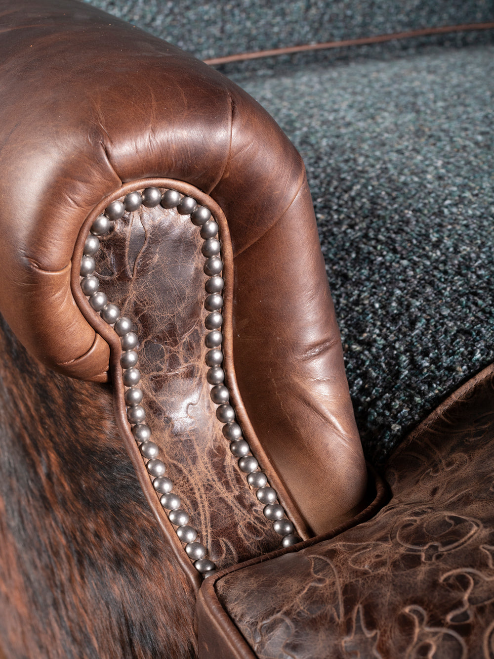 Turquoise Leather & Fabric Chaise Lounge with rolled arm design and embossed leather trim shown in a close-up view.