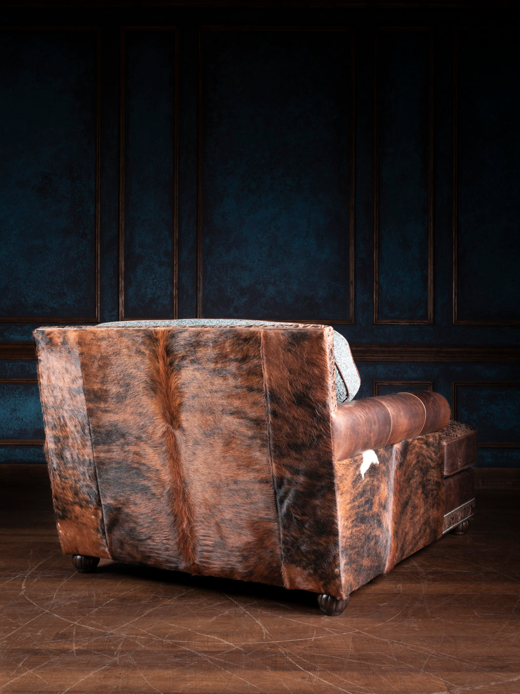 Turquoise Leather & Fabric Chaise Lounge with hair-on-hide back and sides in a moody western space. 